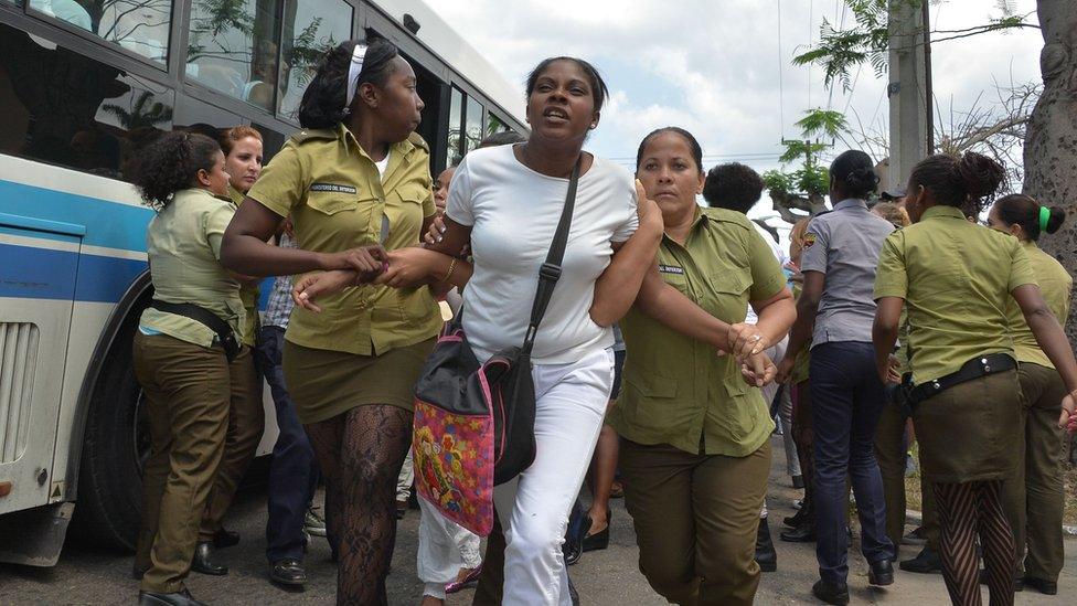 Members of dissident group Ladies in White are detained during their protest on 20 March in Havana