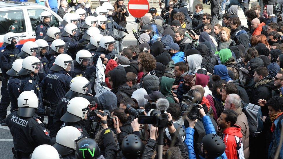 Police officers try to stop protesters on their way in the village of Brenner on the Italian-Austrian border, Sunday, 3 April 2016