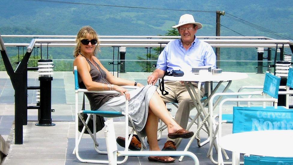 Carolyn Stephens with her father Vincent, sitting outside in what looks like a rooftop cafe