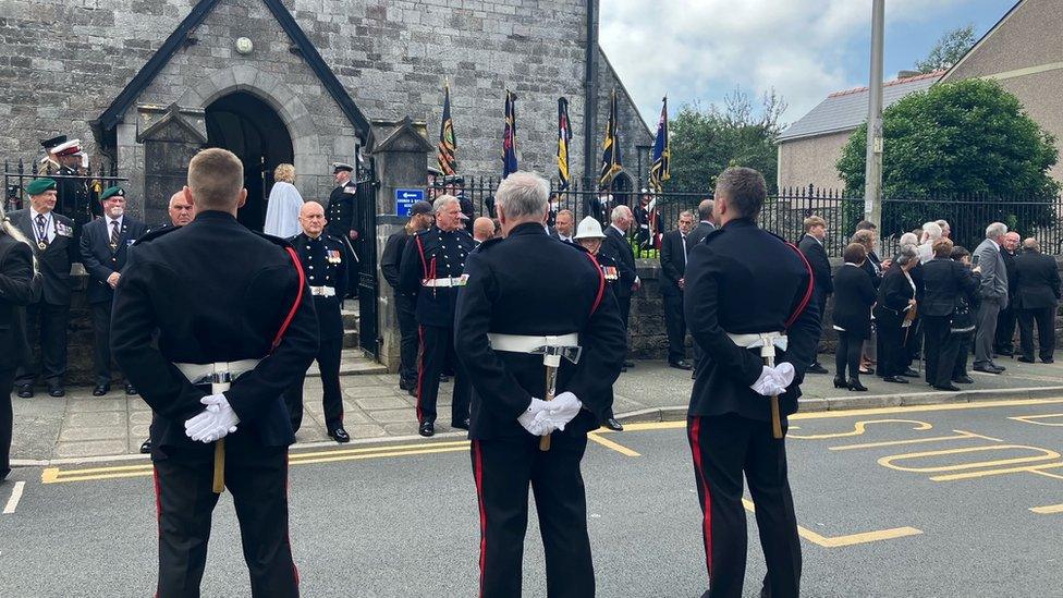 fire brigade, Royal Marines and Royal British Legion lined up ready for the arrival of the coffin