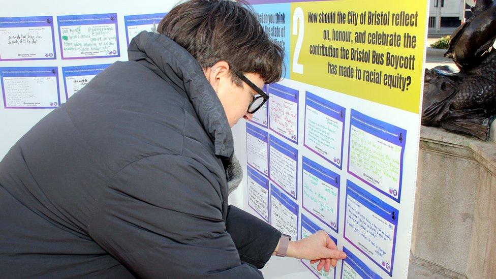 A person signing a card to Martin Luther King