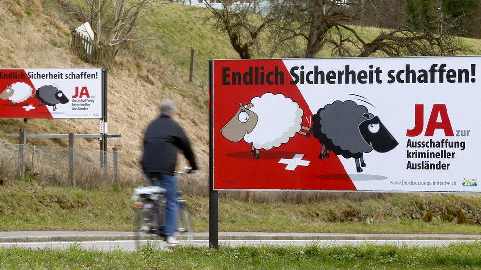 Posters of Swiss People's Party (SVP) demanding to deport criminal foreigners are displayed beside a road in Adliswil, Switzerland, on 11 February 2016