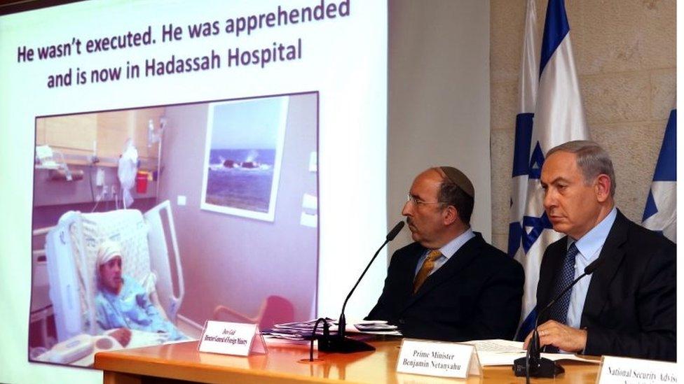 An image of 13-year-old Palestinian Ahmad Manasra is screened during a press conference attended by Israeli Prime Minister Benjamin Netanyahu (R) on 15 October 2015, at the foreign ministry in Jerusalem.