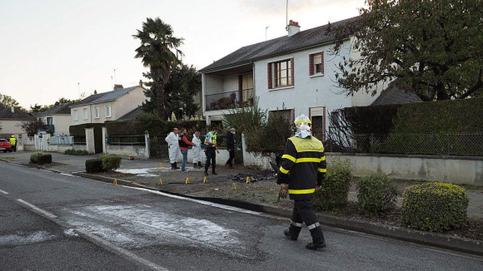 A fireman passes by near the site where an ULM crashed in Loches