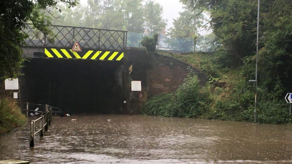 Flooded road under a bridge