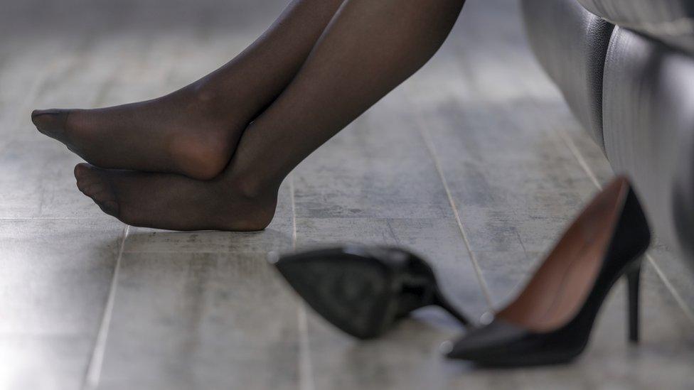 Woman's legs - sitting down, high heels put to one side