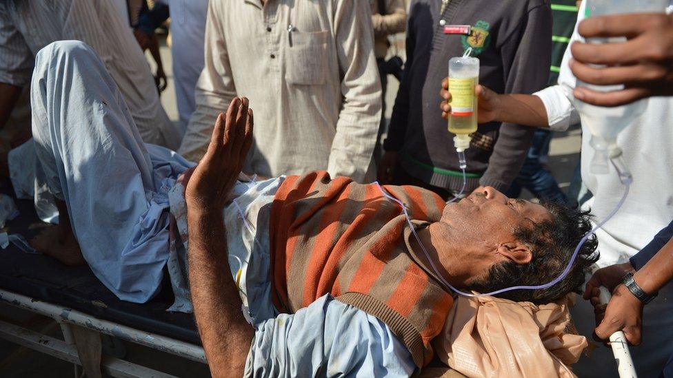 Indian Kashmiri volunteers at a hospital bring in an injured man who was shot during clashes between security forces and protesters in Srinagar on July 10, 2016.