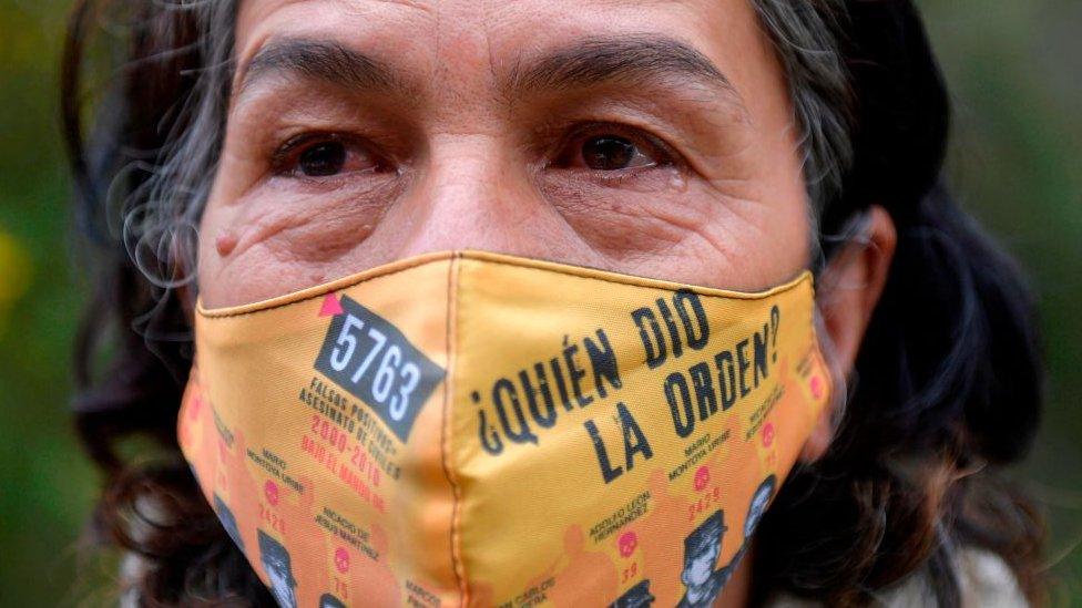 Colombian Doris Tejada, whose son disappeared 12 years ago, and member of the Mothers of False Positives (Mafapo) civil organization, wears a face mask reading Who gave the order? against the spread of the novel coronavirus as she cries during an interview with AFP in Soacha, Colombia, on May 6, 2020.