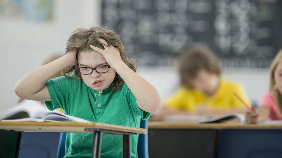 Child with learning disability is frustrated in class