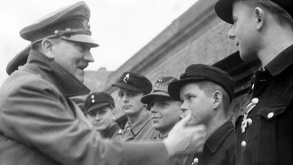 Adolf Hitler congratulates a 12-year-old German soldier