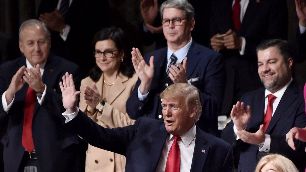 Donald Trump is greeted warmly at the Economic Club of New York