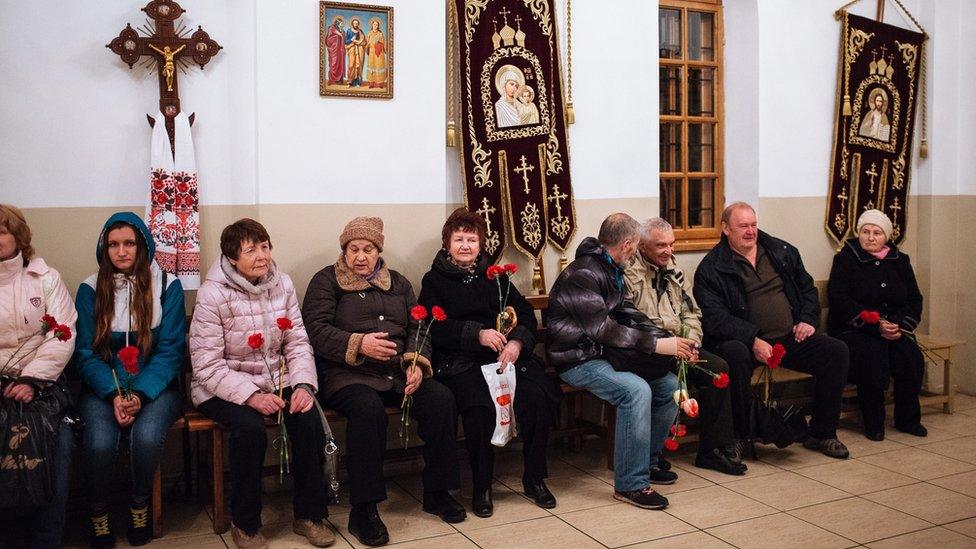 Red flowers are brought for a remembrance service for the victims of Chernobyl in Kiev, on 26 April 2016