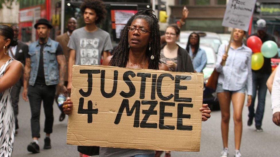 Marcia Riggs hold a placard during the Black Lives Matter protest march for Mzee Mohammed on July 17, 2016 in London, England.