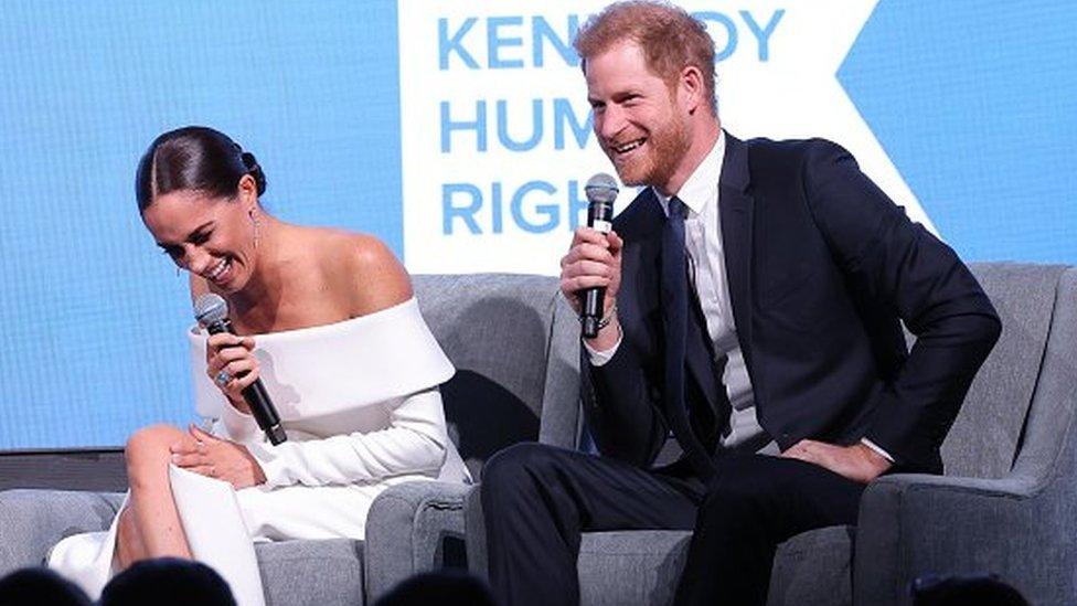 Harry and Meghan laughing at the awards ceremony on Tuesday night