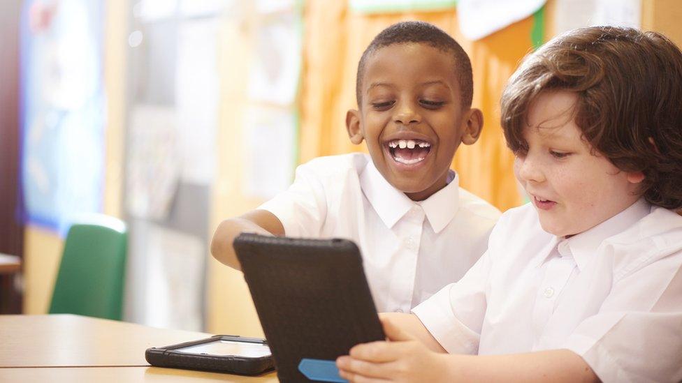 Boys playing on tablet