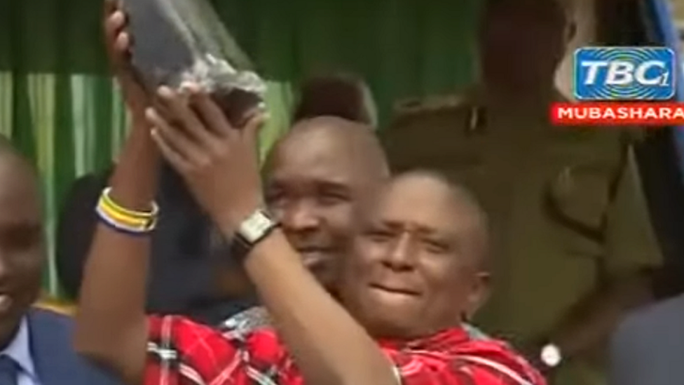 Man holding up a stone