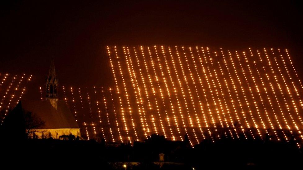 Heaters are lit early in the morning to protect vineyards from frost damage outside Chablis, France, April 7, 2021