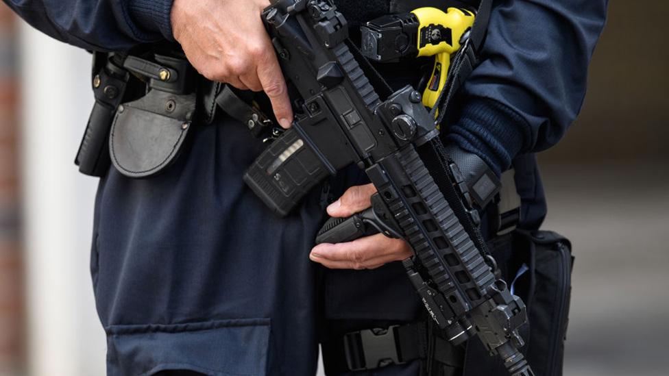 Close-up of armed police's automatic weapon, near Borough Market