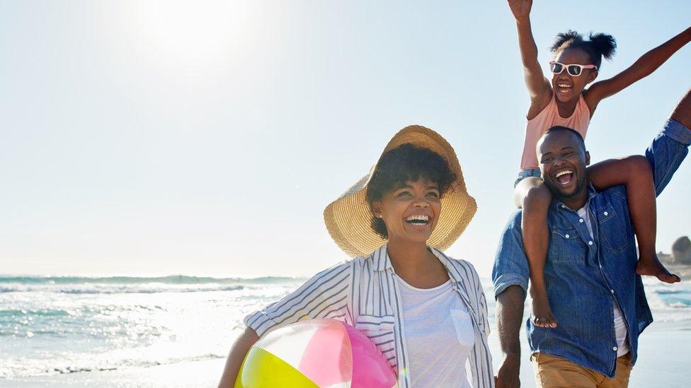 Family-cheering-on-beach.