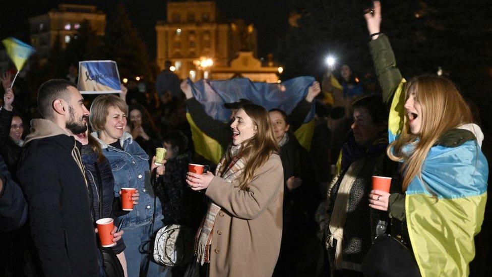 Young people celebrating with Ukrainian flags