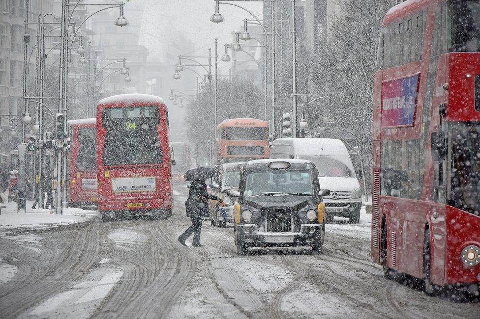 General view of Oxford Street as pedestrians and transport attempt to move around