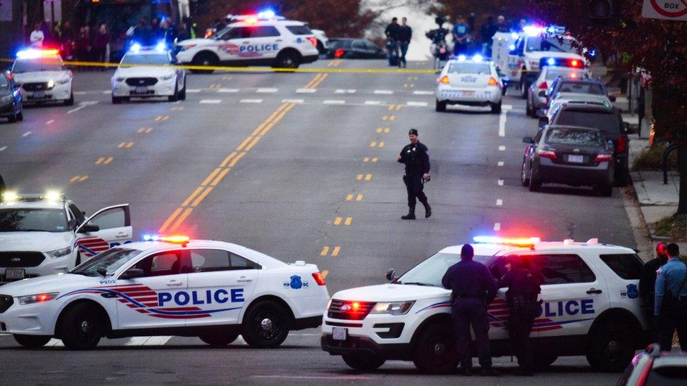 Police secure the scene near Comet Ping Pong in Washington, Sunday, Dec. 4, 2016.