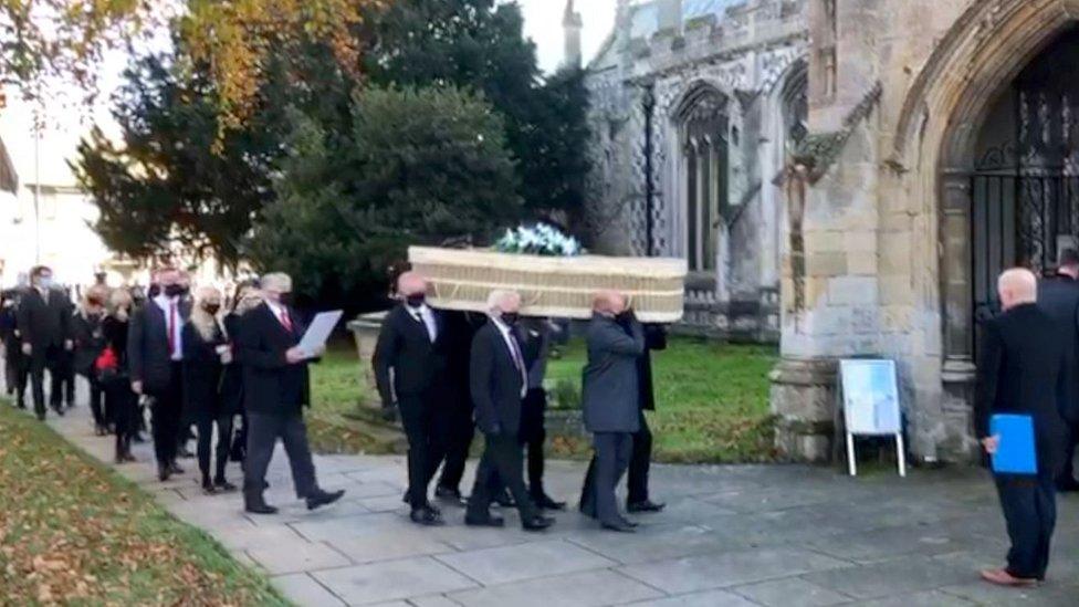 Coffin being carried into church