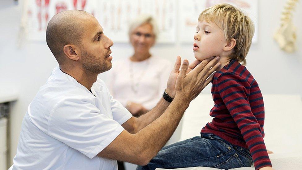 Stock photo of child being examined.