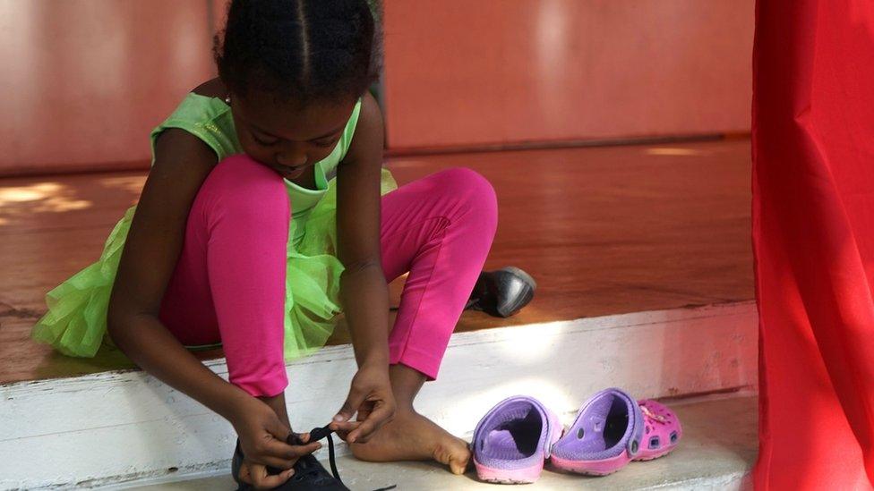 Girl putting dancing shoes on