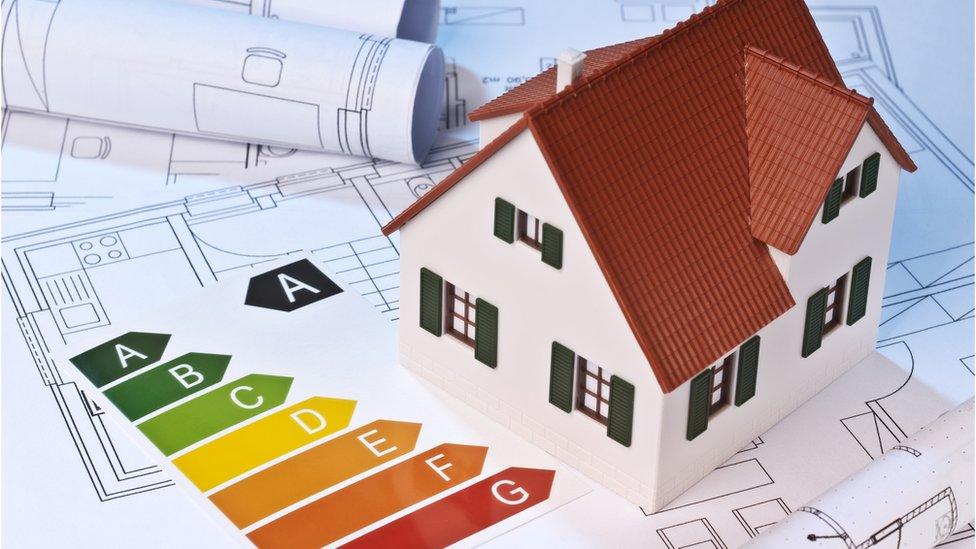 A model of a house and an energy performance certificate on some floorplans