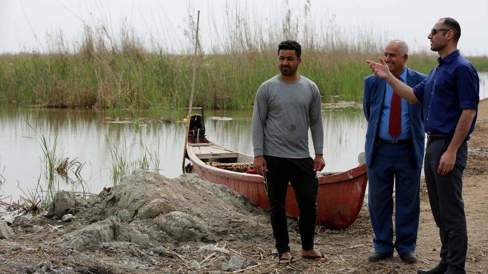 Laith Al-Rubaiy talking to local people in the marshlands