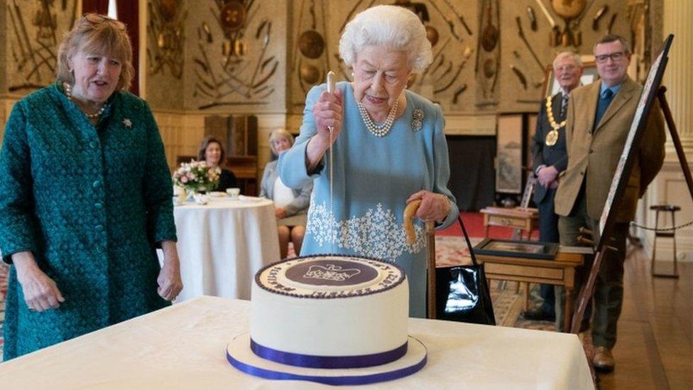 Queen Elizabeth II cuts a cake to celebrate the start of the Platinum Jubilee