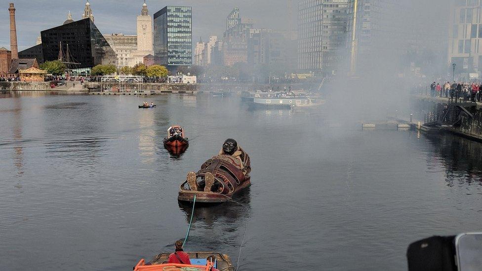 boy giant in boat pulled through dock by boat