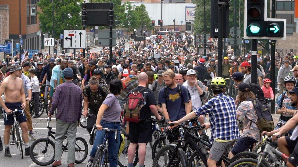 People waiting on their bikes