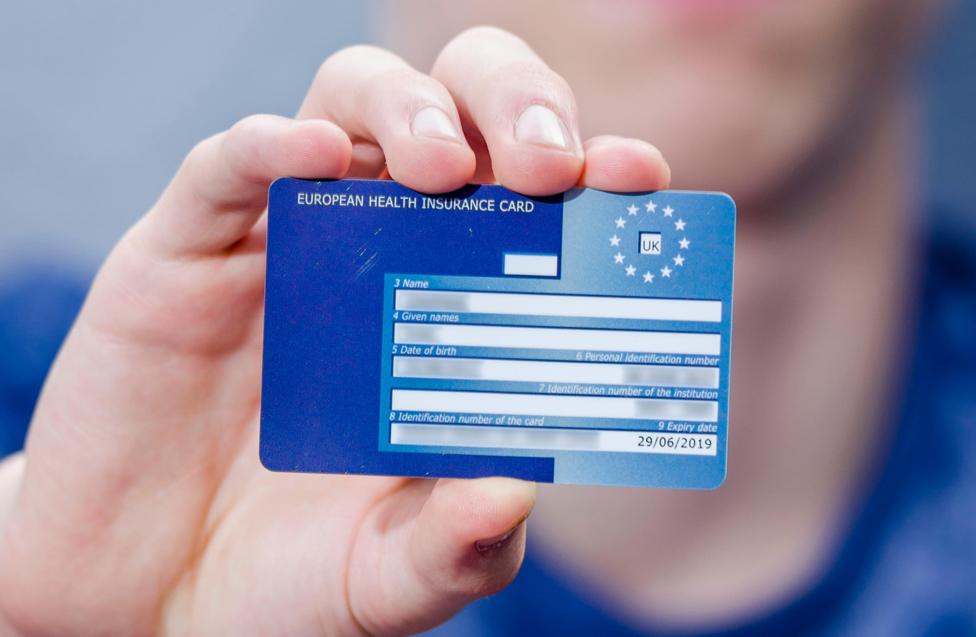 Hand holding a European Health Insurance Card