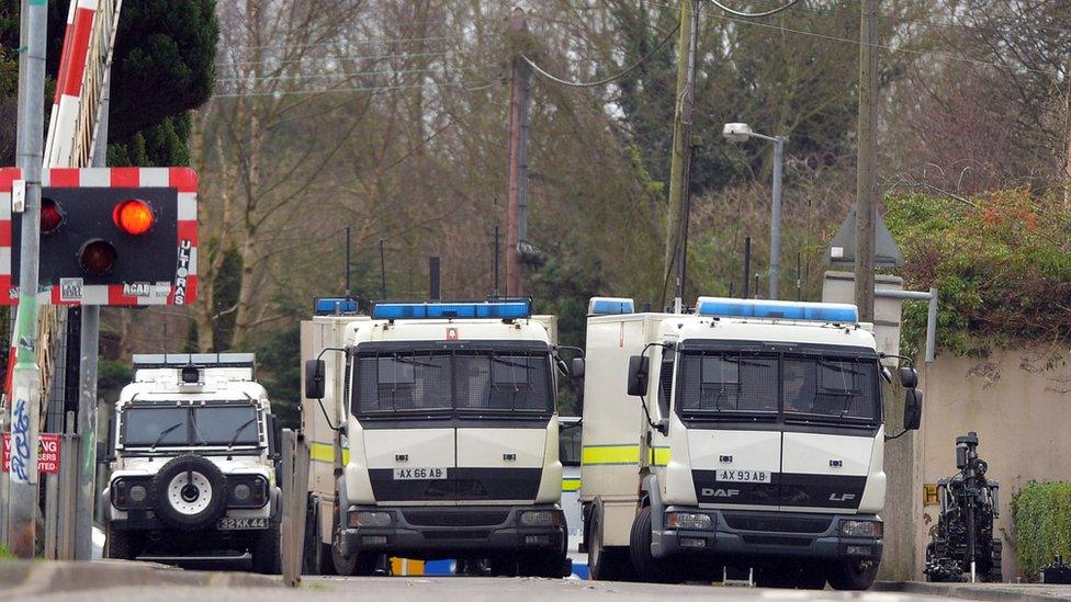 Police vehicles lined up along the railway crossing where the violence took place