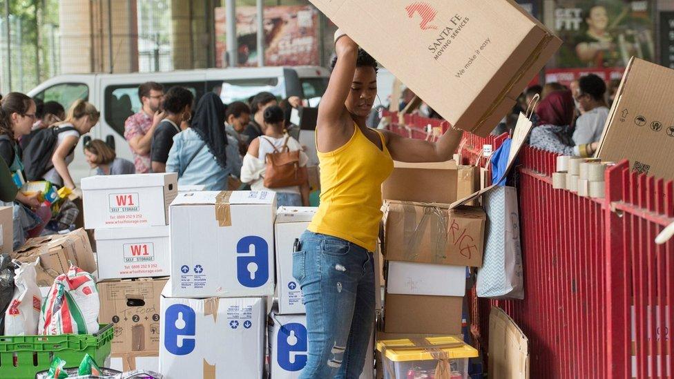 Volunteers organise boxes of donations following near Grenfell Tower in west London