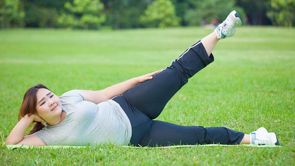 Woman exercising on the grass