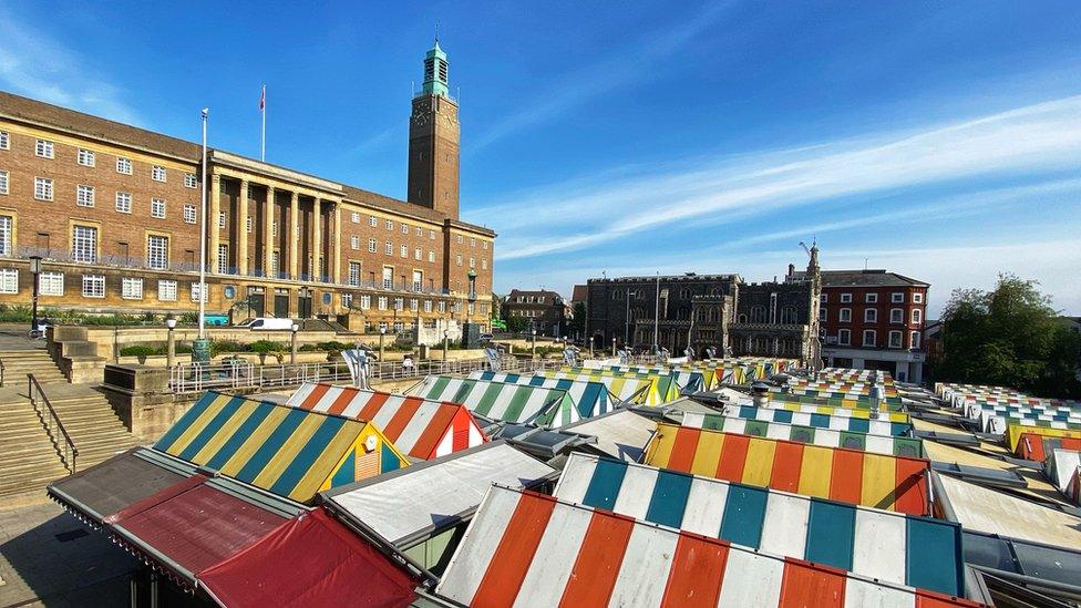 Market stalls at Norwich market, by City Hall