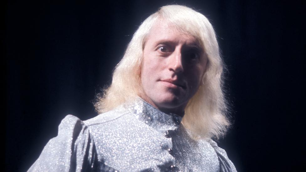 Jimmy Savile looking intently at the camera, sometime in the 1970s