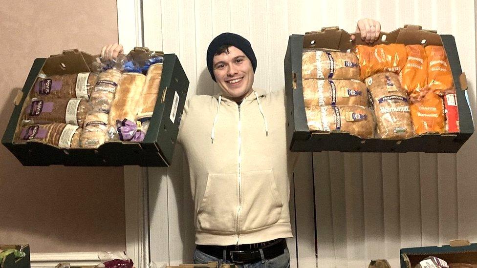 Adam Ellison holding baskets of food