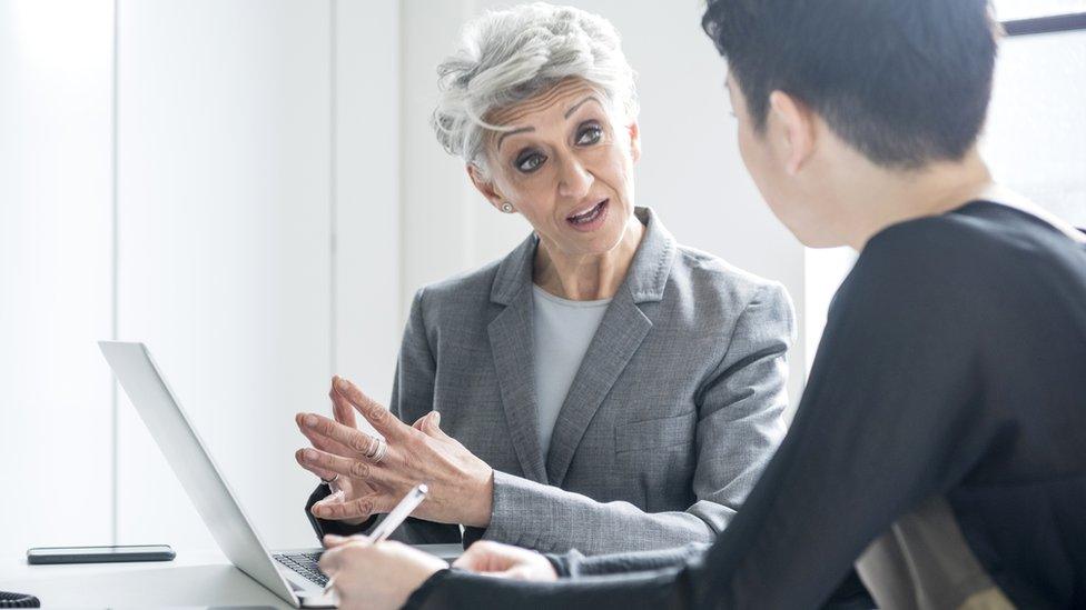 Businesswoman talking to colleague