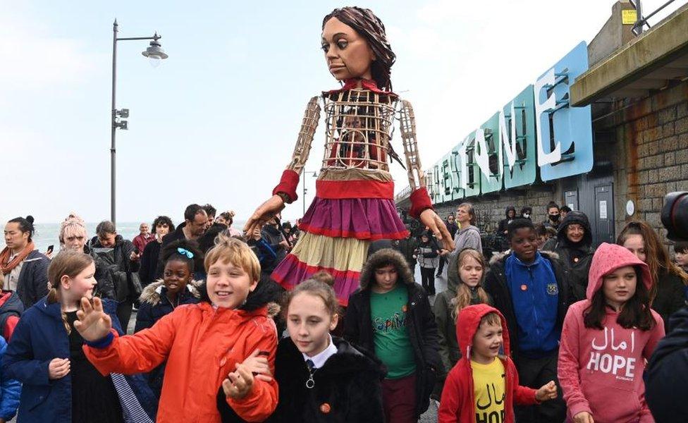 Little Amal and children in Folkestone