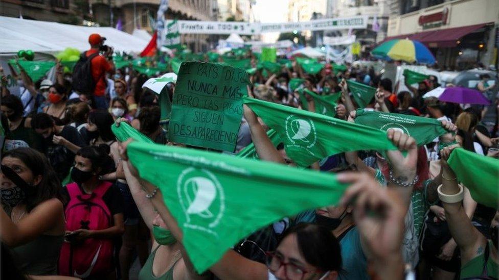 Demonstrators in favour of legalizing abortion hold bandanas as the senate debates an abortion bill, outside the National Congress in Buenos Aires, Argentina, December 29, 2020