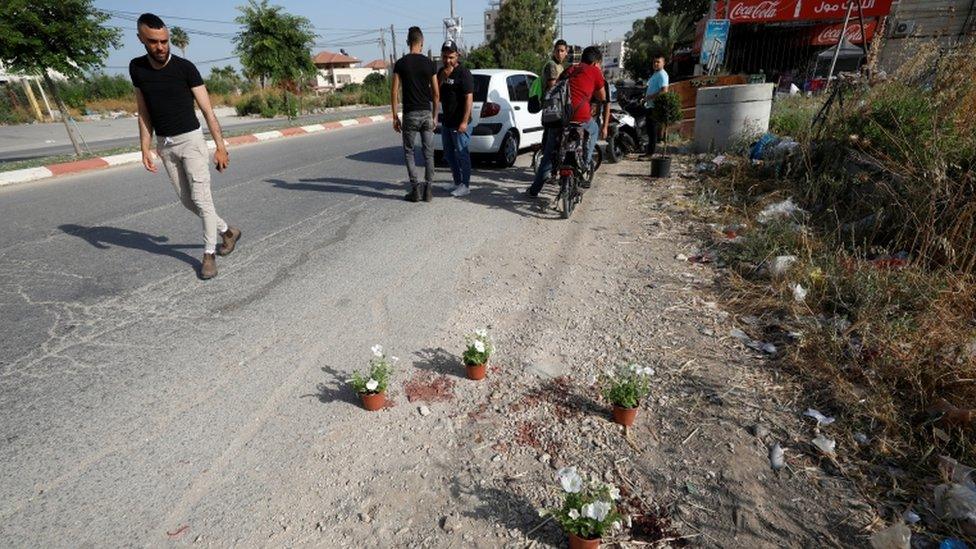 A man looks at the scene where Palestinian security officers were shot dead in Jenin