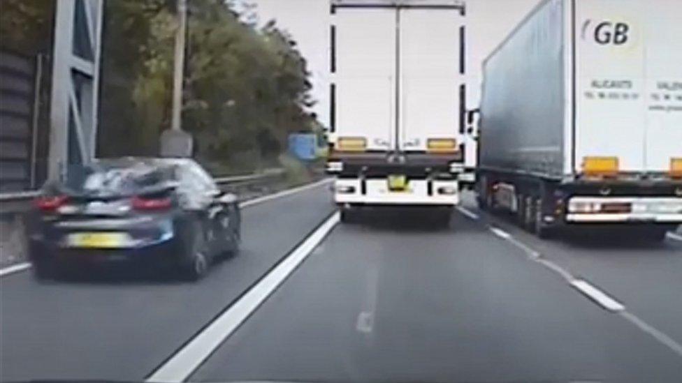 Car undertaking on a motorway hard shoulder