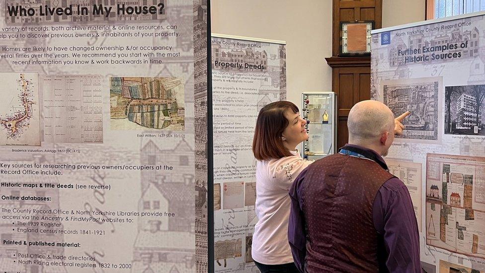 People looking at the exhibition