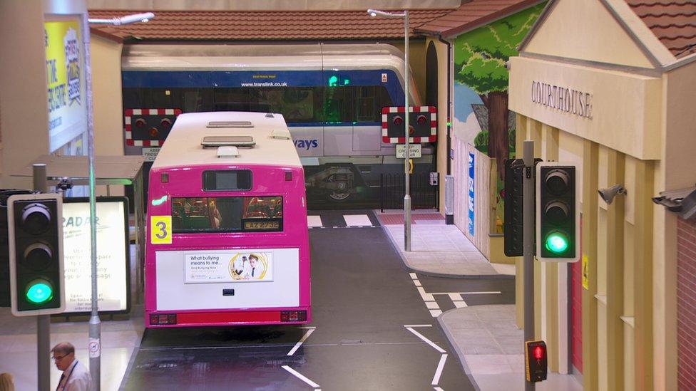 A bus parked on the street in the mock town