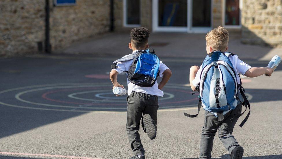 boys-running-into-school