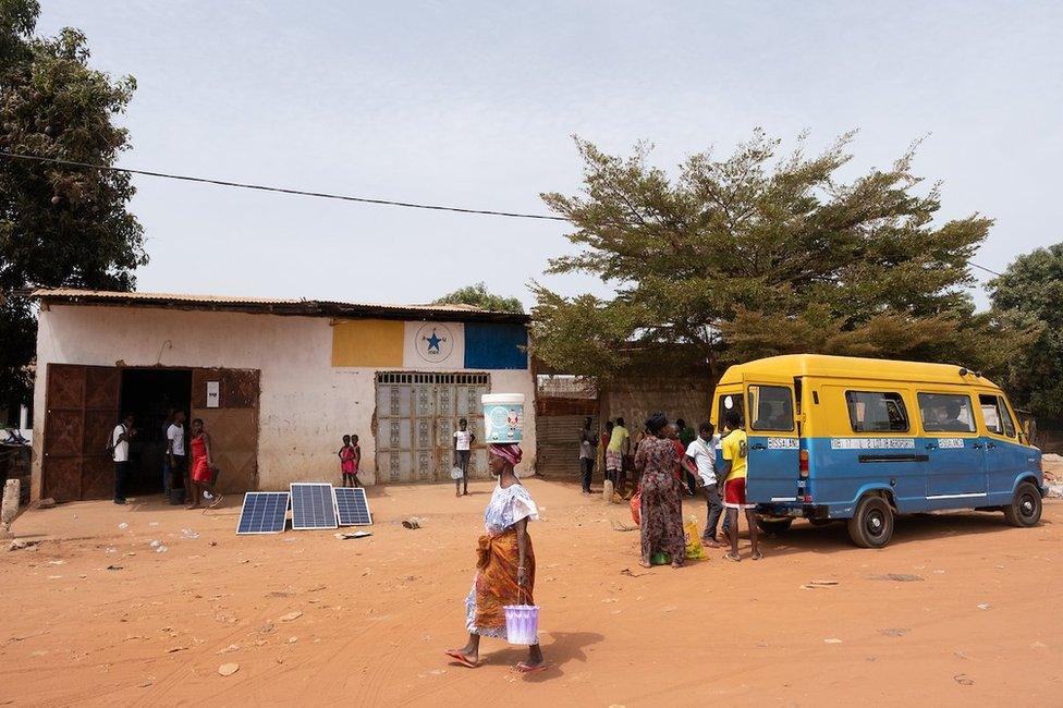 A small store outside the capital, Bissau, has a scale that local cashew producers can use to weigh their crop.